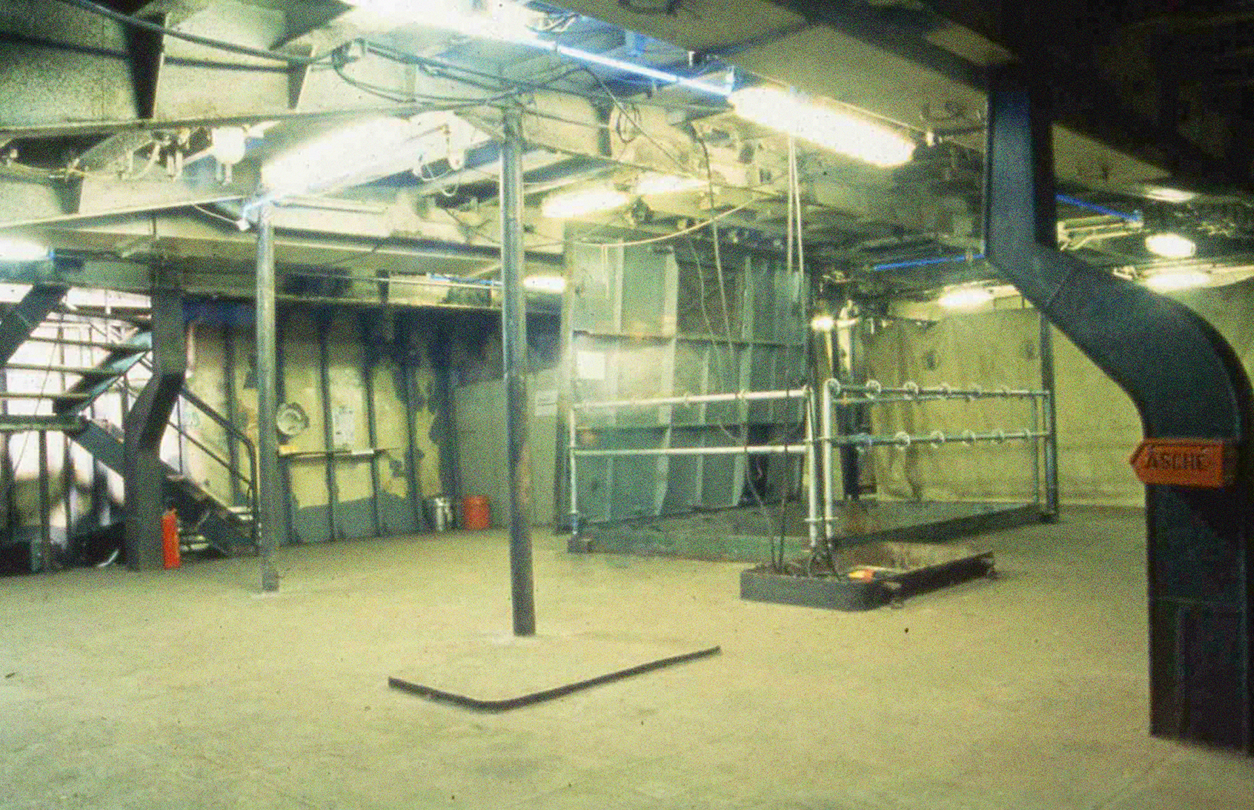 Ein Innenraum der Stubnitz (die Vearbeitung). Neonröhren an der Decke und Metall-Säulen im Raum.
