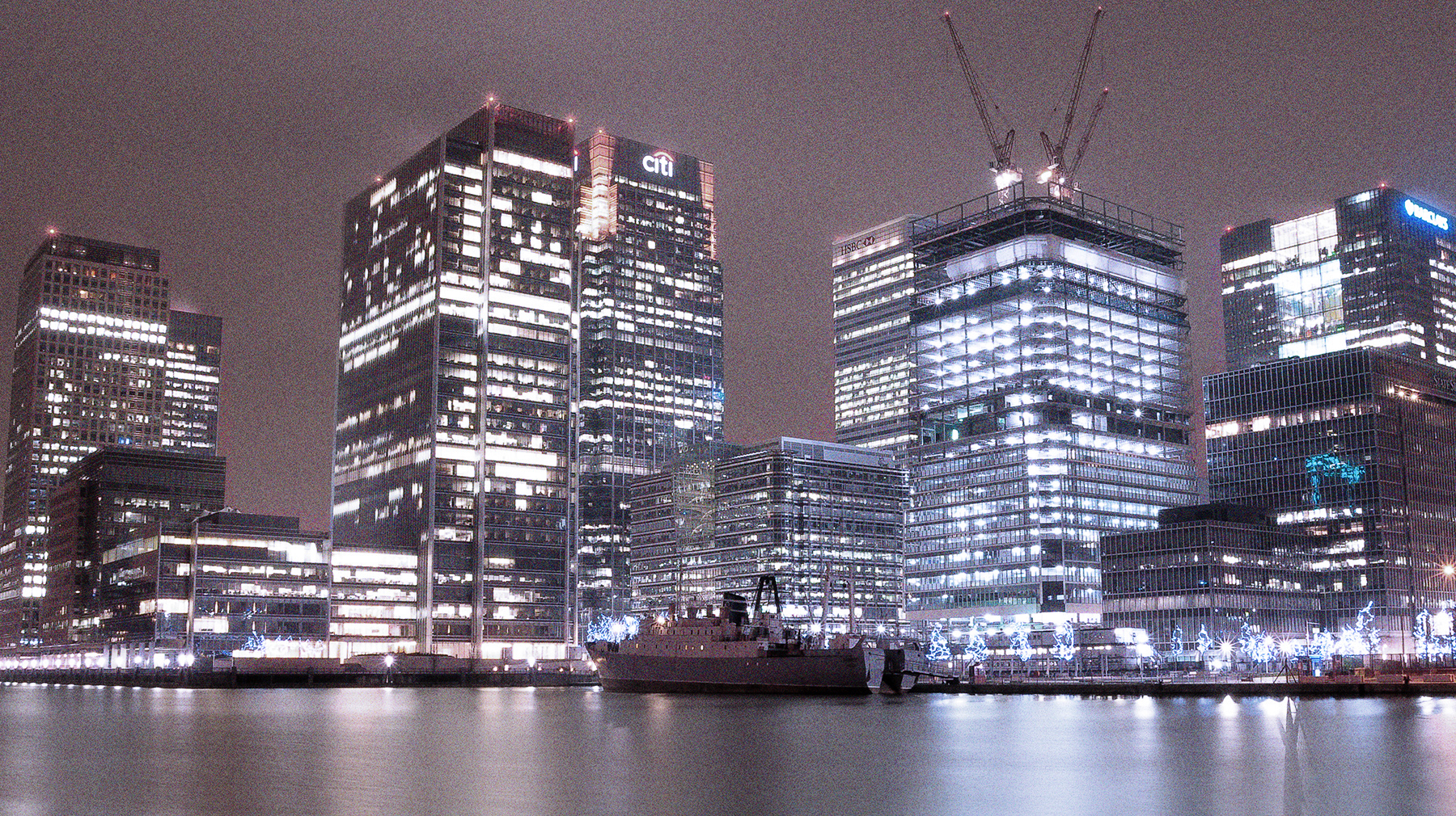 Stubnitz in London / Canary Wharf 2013. Foto aus der Ferne, bei Nacht. Im Hintergrund beleuchtete Hochhäuser.